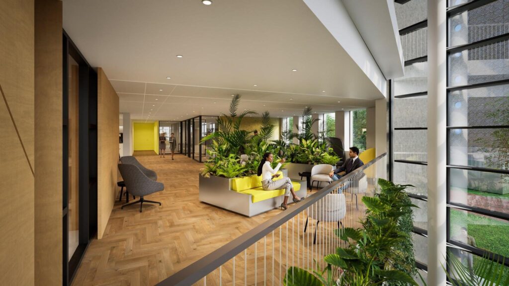 Modern office interior of De Entree with natural light, indoor plants, and people in conversation.